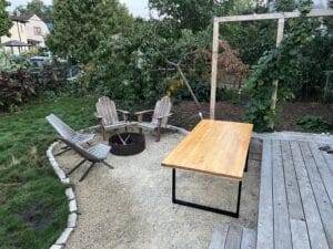 up-close fire ring and gathering space in Phillips with Contender peach tree in back