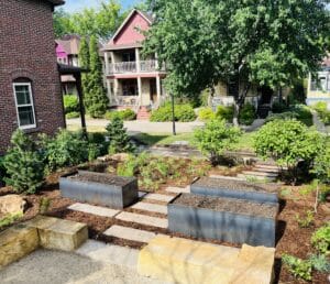 The unplanted mild steel vegetable beds, meandering rectilinear paver path and new perennial prairie garden freshly installed in the Milwaukee Avenue garden.