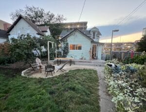 small gravel patio in Phillips Neighborhood surrounded by no mow lawn and edible garden